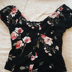 A off the shoulder cropped flower blows.